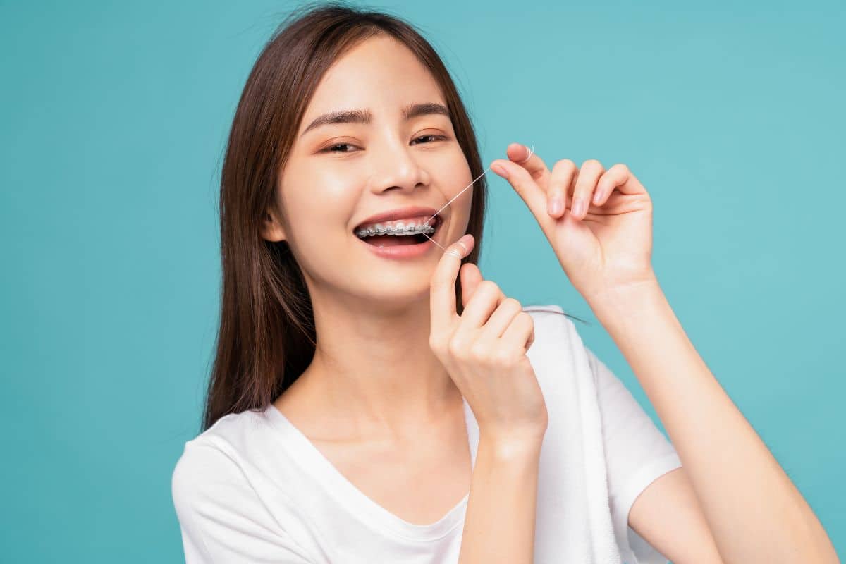 woman flossing with braces