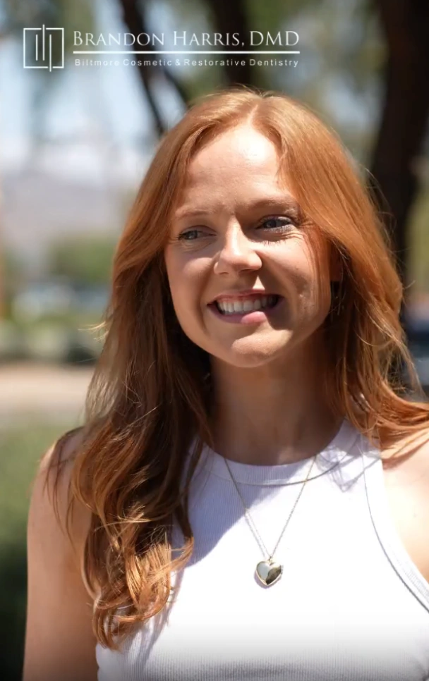 A woman smiling outdoors