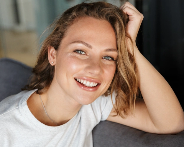 Smiling woman with wavy hair representing cosmetic dentistry results at BCR Dentistry