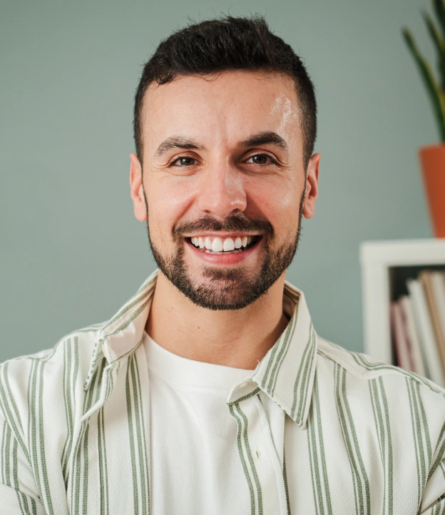 A smiling man with healthy teeth next to web copy explaining stress-free dental fillings at Biltmore Cosmetic & Restorative Dentistry in Phoenix.