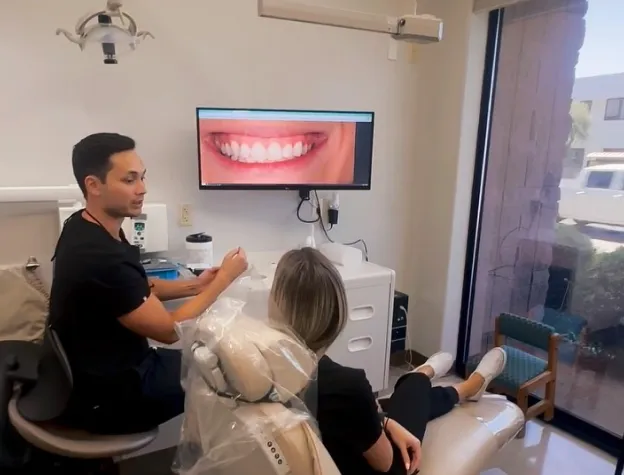 Dr. Brandon Harris discussing treatment options with a patient at Biltmore Cosmetic & Restorative Dentistry