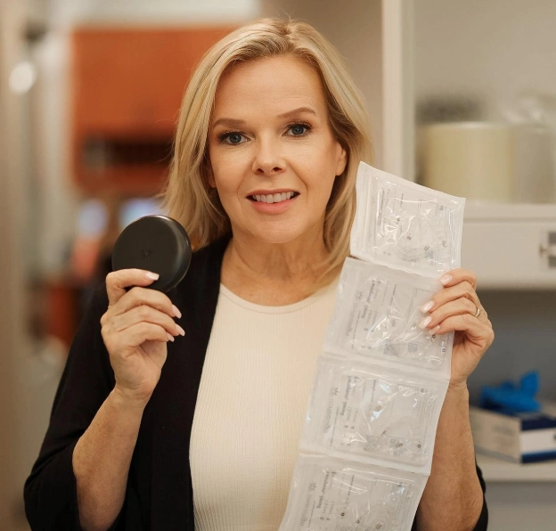 A woman holding an Invisalign case and clear aligner packaging next to text about transferring your Invisalign orthodontic treatment to a dentist in Phoenix.