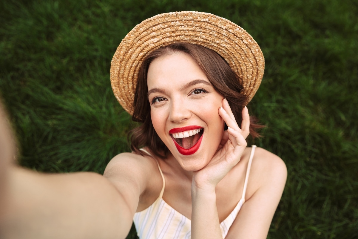 a beautiful women taking a selfie with smile after received cosmetic dental treatment in Phoenix